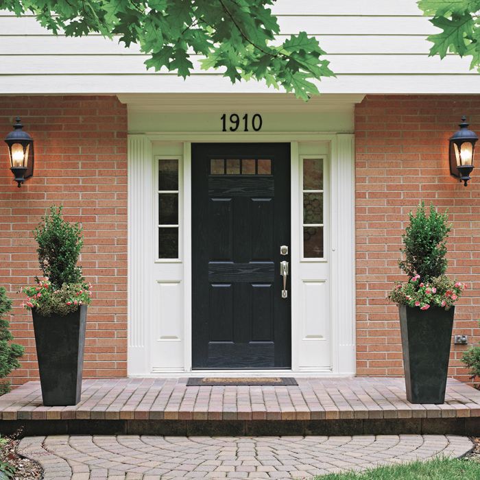 GOOD This is a good start, but this arrangement isn’t quite enough, is it? The overall effect doesn’t have enough heft to balance the dark door or the large apron. Here is what works with this planting:
Equally spaced, matching containers are symmetrical
