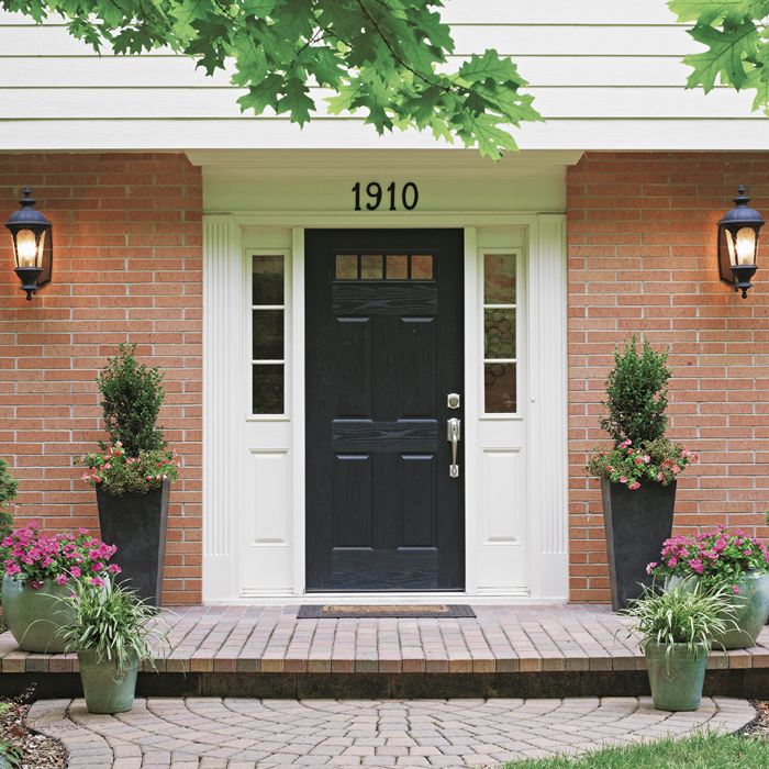 BETTER So we added to it. We moved the tall planters back to make room for a few containers in front. This grouping is headed in the right direction to balance out the black door, but the door still outweighs the arrangement. Here’s what we like about thi